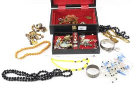 A collection of costume jewellery, including silver bangles, silver buckle rings, assorted rings,