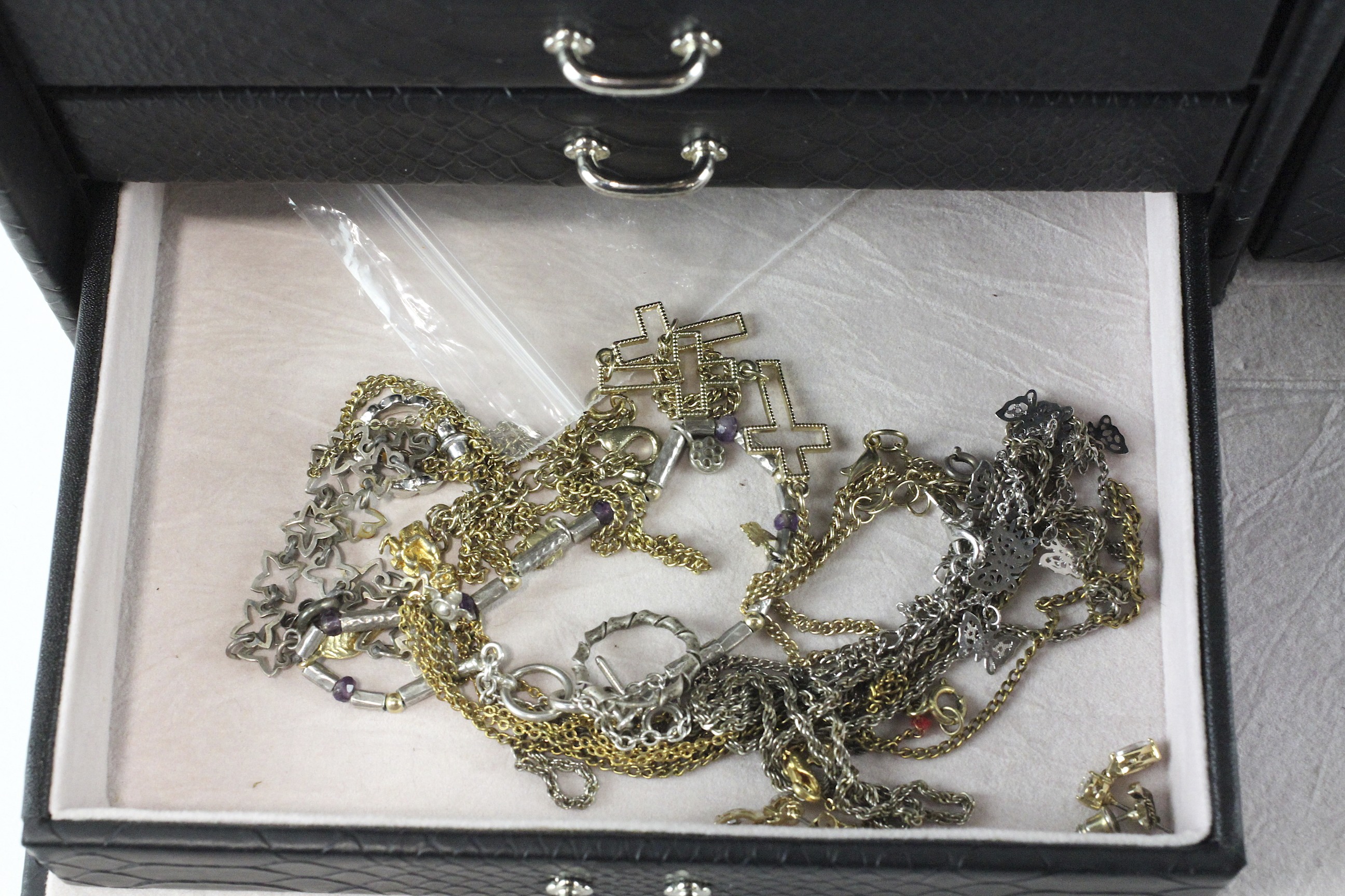 A black jewellery box containing a collection of costume jewellery, including brooches, necklaces, - Image 2 of 4