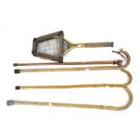 A collection of vintage walking sticks and tennis racquet,