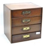 A miniature wooden chest of drawers,