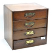 A miniature wooden chest of drawers,