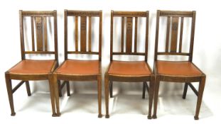 A set of four 20th century chairs, the oak framed with carved details and tapered supports,