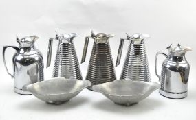 Five metal water jugs and two bowls,