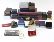 An assortment of jewellery boxes with several items of jewellery, including ring cases,