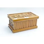 A contemporary carved wooden box, the hinged lid decorated with floral motifs