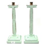 A pair of 20th century green painted candlesticks, in the gothic style,