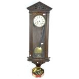 An early 20th century oak cased Vienna wall clock,