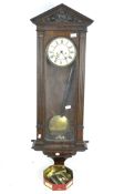 An early 20th century oak cased Vienna wall clock,