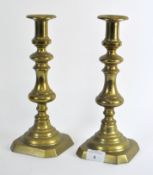A pair of late 19th century brass candlesticks,