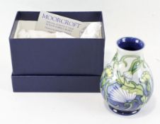 A contemporary Moorcroft vase, of squat form, signed and dated to base 1997, in original box, 13.