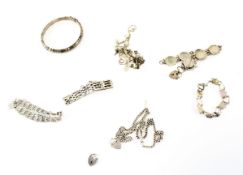 An assortment of silver jewellery, including a bangle, fob chain, padlock bracelets,