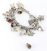 A silver charm bracelet, containing twenty silver and silver plated charms,