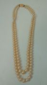 A vintage 9ct gold clasped two string pearl necklace,