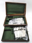 An early/mid century Oak canteen containing later silver plated flatware,