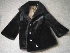 A vintage dark chocolate brown fake fur coat with large collar and three buttons,