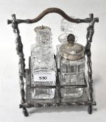 A Victorian four piece glass condiment set in a silver plated bamboo style stand with cane handle
