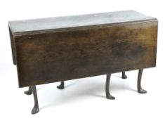 A 19th century stained wooden Pembroke dining table, raised upon cabriolet supports,