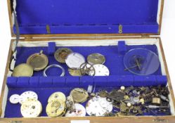A collection of pocket watch components, including movements, faces, cogs and more,