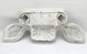 A ceramic sink surround, of curved form with a shell soap dish,