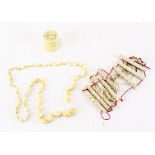 A selection of late 19th/early 20th century ivory wares, to include a bead necklace,