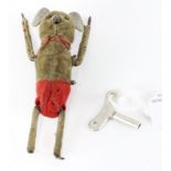 A Schuco clockwork tumbling mouse, circa 1930, brown velvet with red shorts, circa 1930, with key,