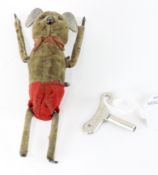 A Schuco clockwork tumbling mouse, circa 1930, brown velvet with red shorts, circa 1930, with key,