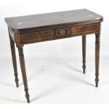 A late 19th Century mahogany card table, raised upon turned supports of graduating form,