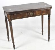 A late 19th Century mahogany card table, raised upon turned supports of graduating form,