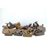 A collection of approximately 20 vintage wooden planes,