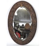 A contemporary stained wooden framed wall mirror,