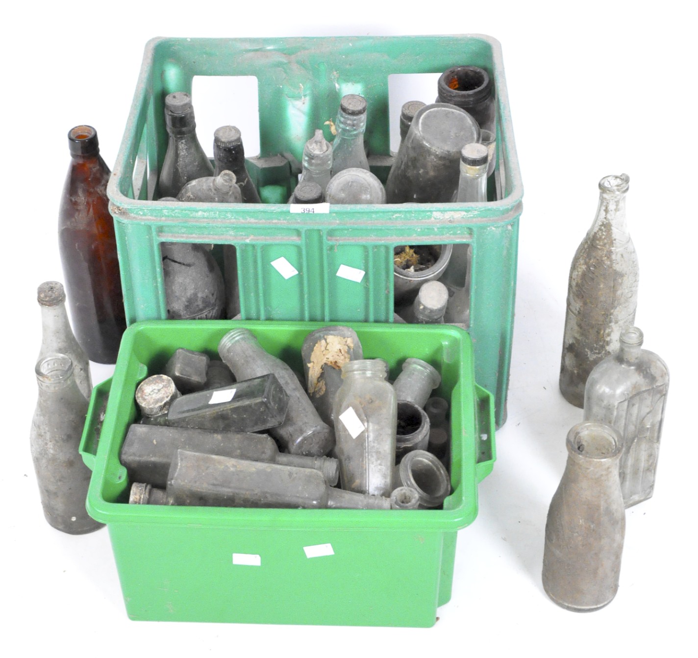 A collection of various vintage glass storage bottles,