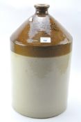 An early 20th century Stoneware liquid jug, from John White & Co, wine and spirit merchants,