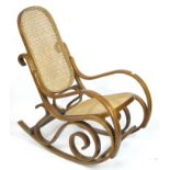 An early 20th century bentwood and bergere rocking chair,