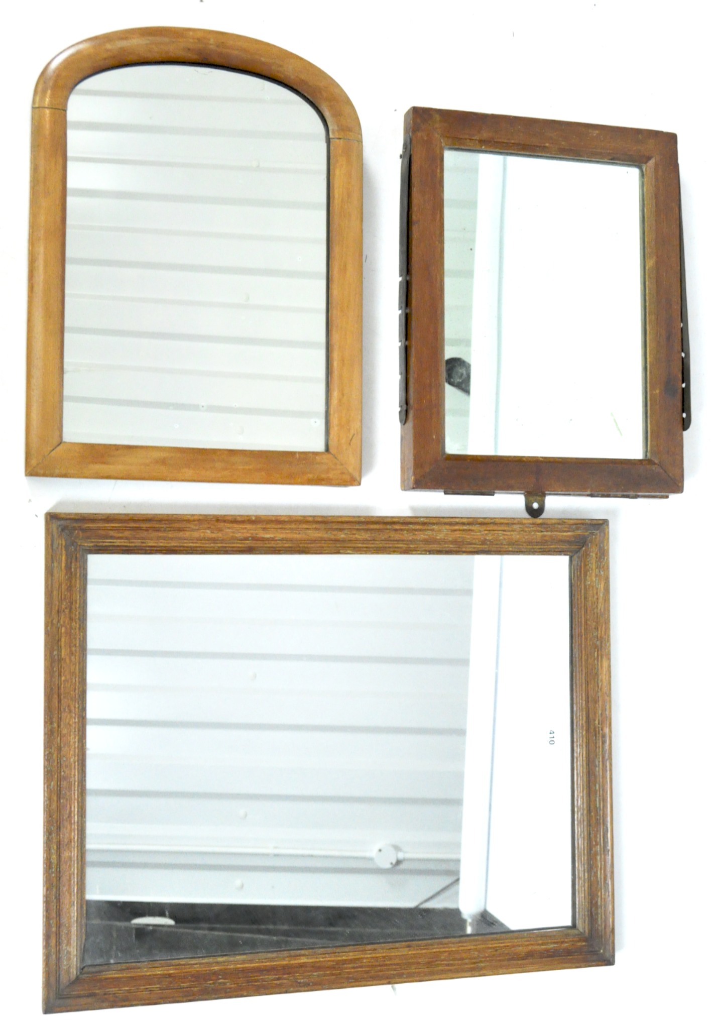 Three mirrors including a campaign example, all with wooden frames,