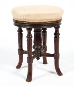 A late 19th/early 20th century upholstered walnut piano stool,