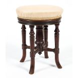 A late 19th/early 20th century upholstered walnut piano stool,