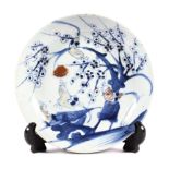 A Korean style porcelain blue and white plate, painted with birds perched on prunus branches,