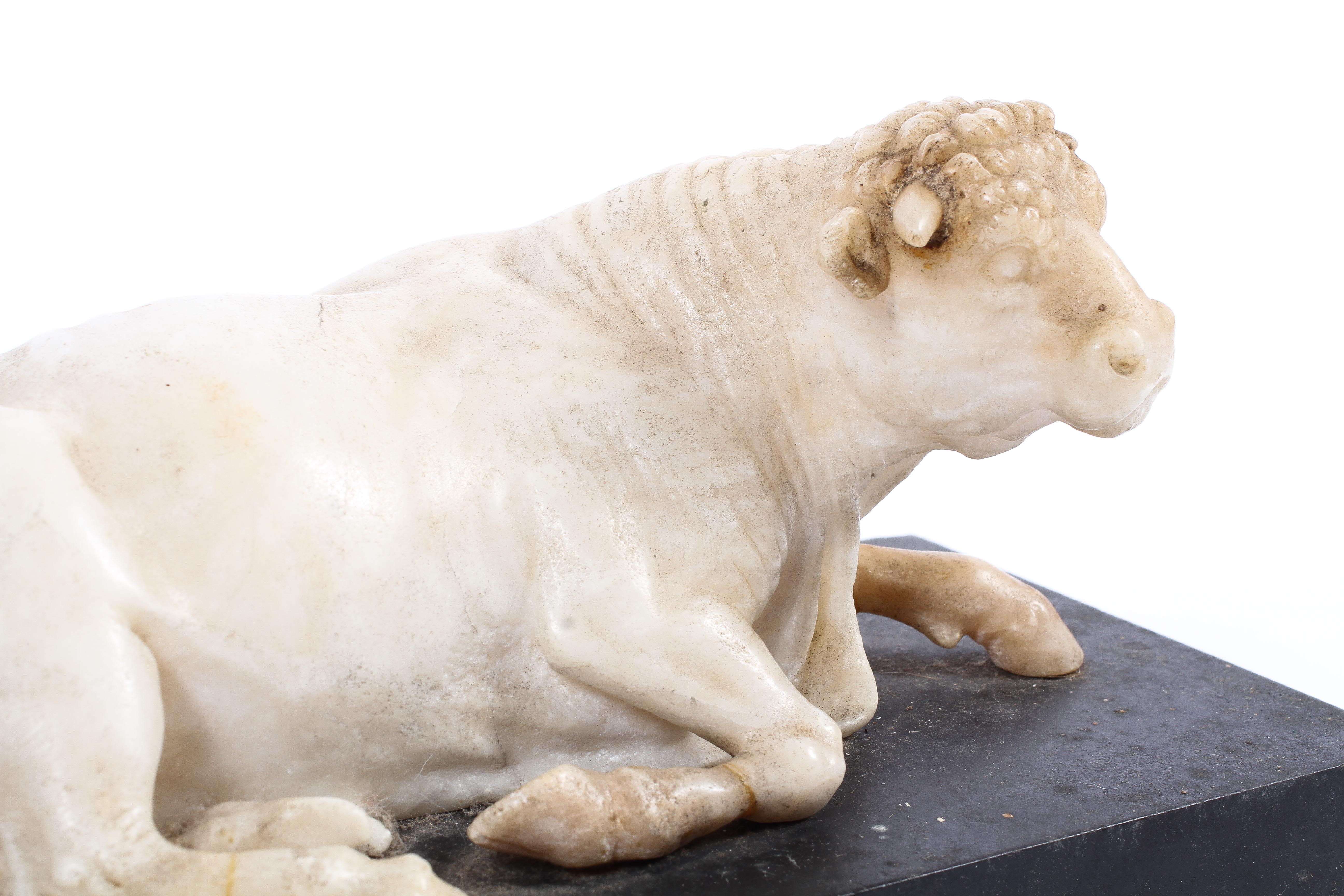A 19th century carved alabaster model of a recumbent bull, perhaps by Joseph Hall Marble Works, - Image 2 of 2