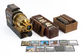 A tin and brass Magic Lantern and a collection of glass and moving hand painted slides