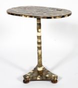 An early 20th century horn veneered oval occasional table of oval form,