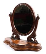 A Victorian mahogany oval dressing table swing mirror with oval mirror on pierced scroll supports