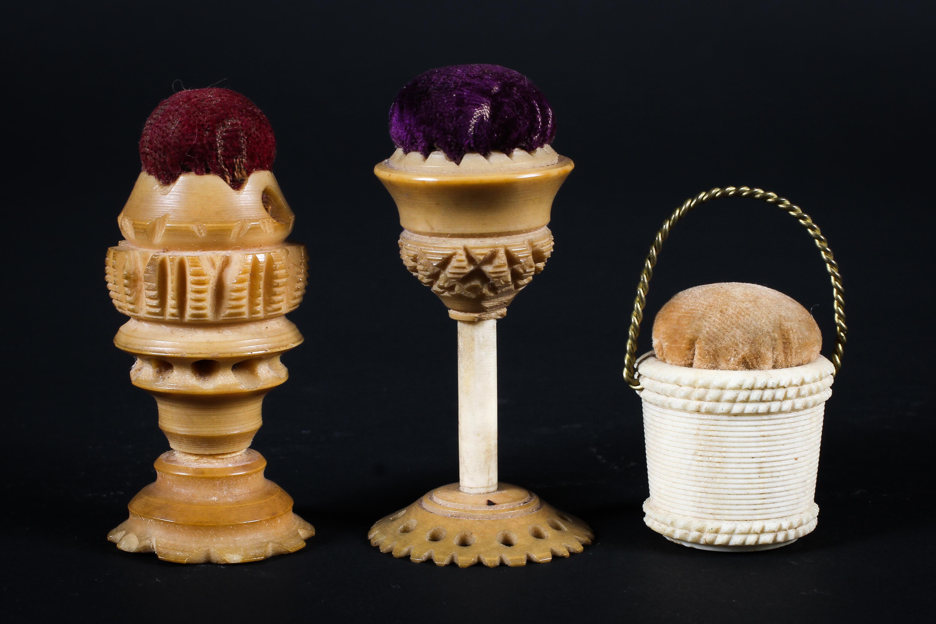 Three late 18th/early century carved pin cushions,