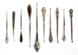 A collection of sterling silver handled button hooks