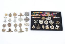 A Collection of military cap badges and ribbons,