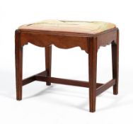 A Georgian style mahogany rectangular hall stool, on tapering reeded legs with scroll apron,