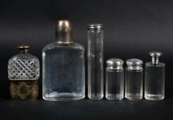 A collection of hallmarked sterling silver topped glass dressing table items together with a silver