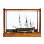 An oak and glass cased scratch built model of HMS Bounty, in a naturalistic setting,.