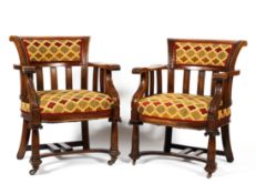 A pair of carved oak upholstered armchairs, late19th/early 20th century,