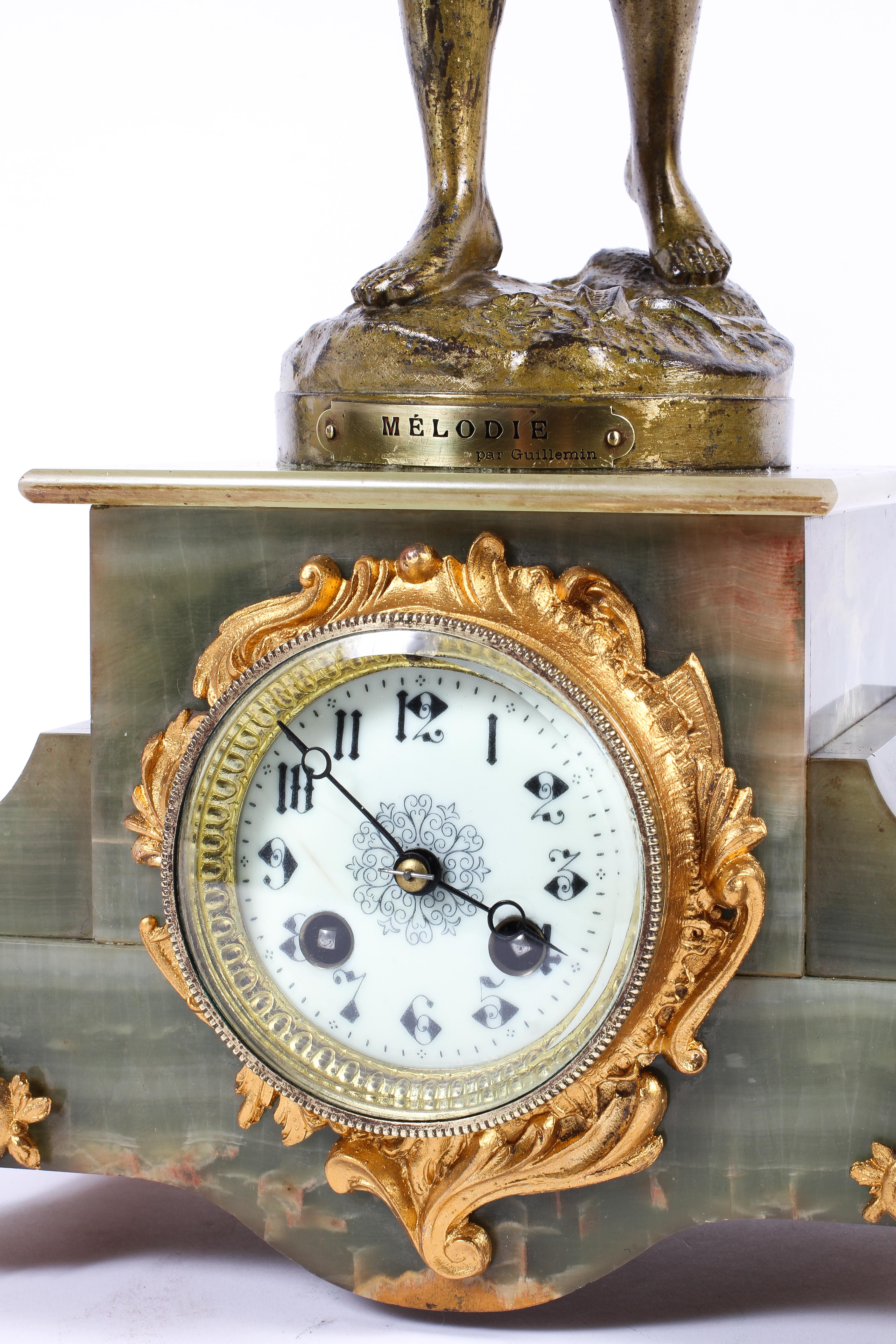 A French onyx and gilt-metal mounted three piece figural clock garniture, - Image 2 of 3