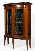 An Edwardian mahogany glazed marquetry display cabinet, of canted form,